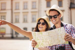 Happy tourist sightseeing city with map